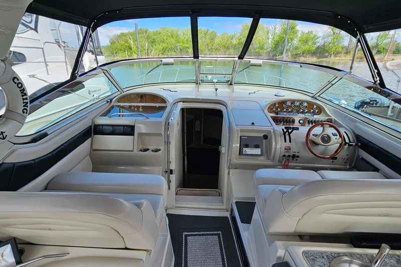 Slide: The Image of Interior view of a 1997 Regal Commodore 402 boat cockpit with steering wheel and controls. - 11
