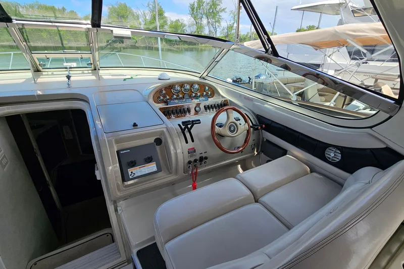Slide: The Image of 1997 Regal Commodore 402 boat cockpit with steering wheel and control panel. - 15