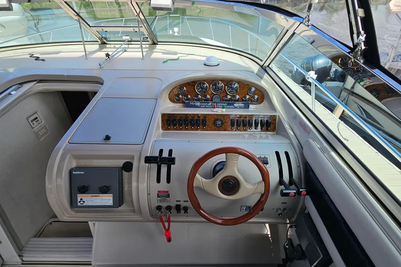 Slide: The Image of 1997 Regal Commodore 402 boat cockpit with steering wheel and control panel. - 16