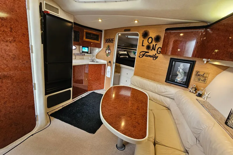 Slide: The Image of Interior of a 1997 Regal Commodore 402 yacht with cozy seating and kitchenette. - 18