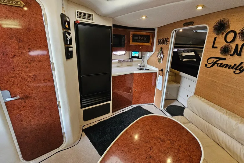 Slide: The Image of 1997 Regal Commodore 402 interior with kitchenette, seating, and cozy decor. - 20
