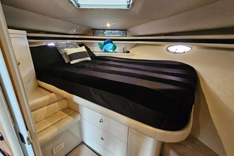 Slide: The Image of Luxurious cabin interior of 1997 Regal Commodore 402 yacht with cozy bed and ambient lighting. - 23