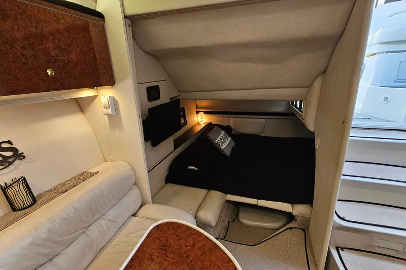 Slide: The Image of Interior of 1997 Regal Commodore 402 yacht with cozy seating and sleeping area. - 26
