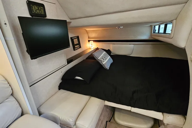 Slide: The Image of Cozy cabin interior of 1997 Regal Commodore 402 with bed, TV, and ambient lighting. - 27
