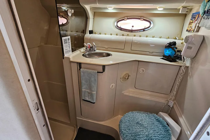 Slide: The Image of 1997 Regal Commodore 402 boat bathroom with sink, mirror, and porthole window. - 28