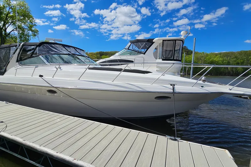 Slide: The Image of 1997 Regal Commodore 402 yacht docked on a sunny day with blue skies. - 3