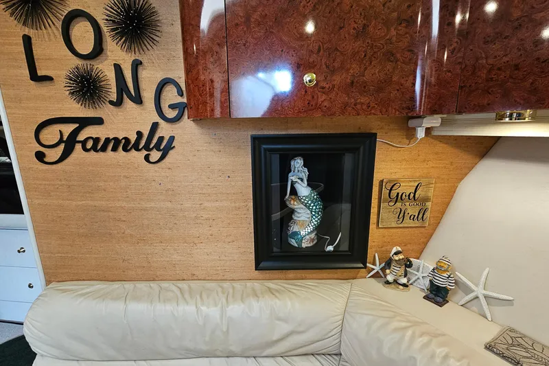 Slide: The Image of Interior of 1997 Regal Commodore 402 with nautical decor and family-themed wall art. - 30