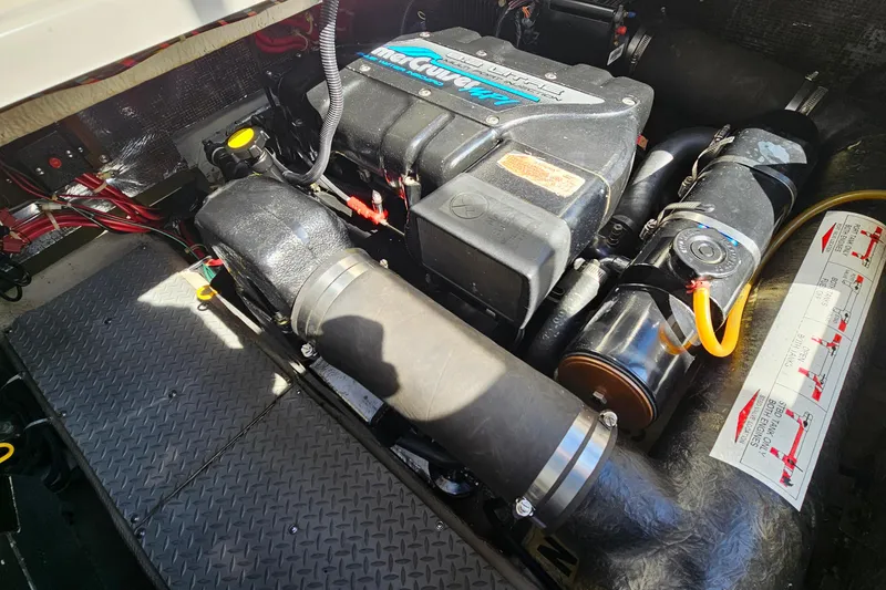 Slide: The Image of Engine compartment of a 1997 Regal Commodore 402 boat, featuring a MerCruiser engine. - 34