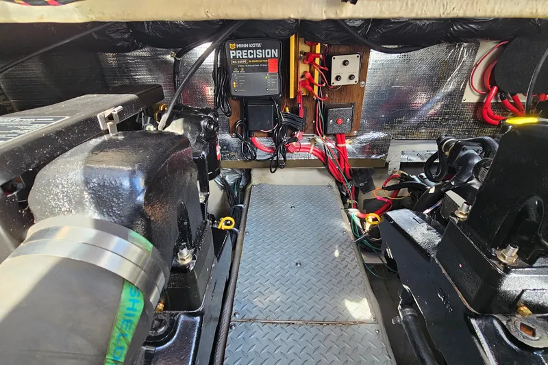 Slide: The Image of Engine compartment of a 1997 Regal Commodore 402 boat with wiring and equipment. - 35