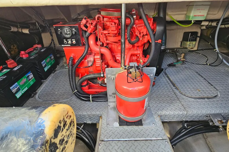 Slide: The Image of Engine room of a 1997 Regal Commodore 402 with red engine and batteries. - 36