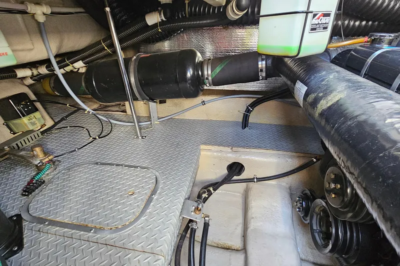 Slide: The Image of Engine compartment of a 1997 Regal Commodore 402 boat, showing hoses and components. - 37