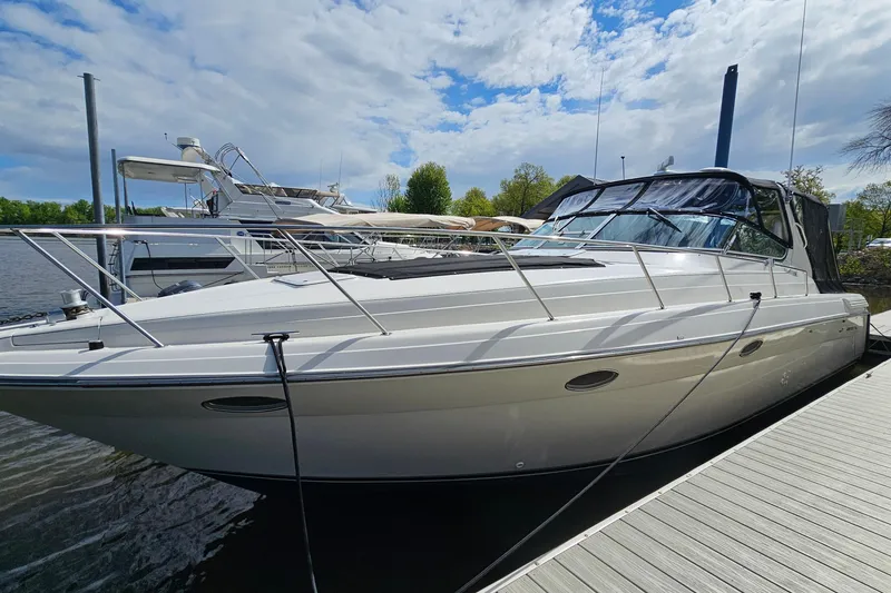 Slide: The Image of 1997 Regal Commodore 402 yacht docked on a sunny day with blue sky. - 4