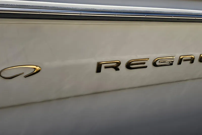 Slide: The Image of Close-up of 1997 Regal Commodore 402 boat logo in gold lettering. - 41