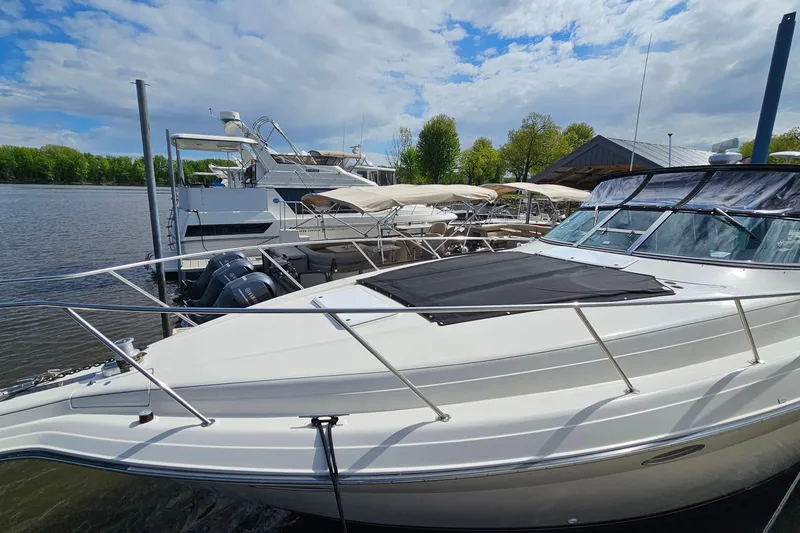 Slide: The Image of 1997 Regal Commodore 402 yacht docked at marina under partly cloudy sky. - 5