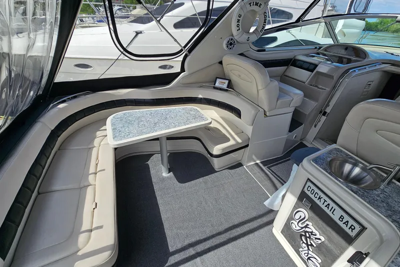 Slide: The Image of Luxurious 1997 Regal Commodore 402 yacht interior with seating, table, and cocktail bar. - 7