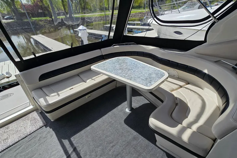 Slide: The Image of Luxurious seating area on a 1997 Regal Commodore 402 yacht with a stylish table. - 9