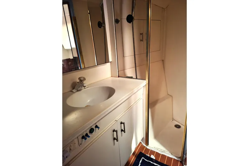 Slide: The Image of Cozy cabin bed with fish-themed bedding and starfish pillows on a 1993 Ocean Yachts 38 Super Sport. - 21
