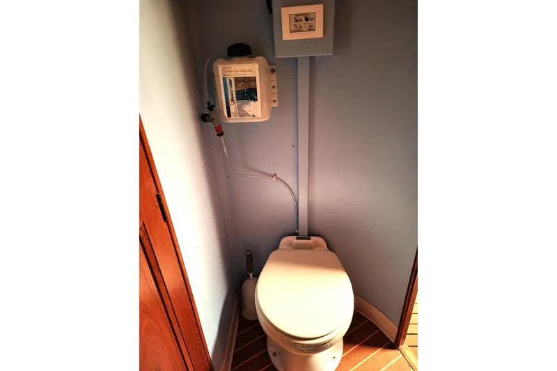 Slide: The Image of 1993 Ocean Yachts 38 Super Sport bathroom with marine toilet and wall-mounted control panel. - 23