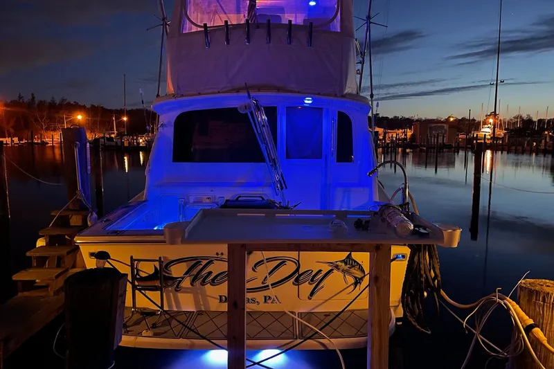 Slide: The Image of 1993 Ocean Yachts 38 Super Sport illuminated at night in a marina setting. - 3