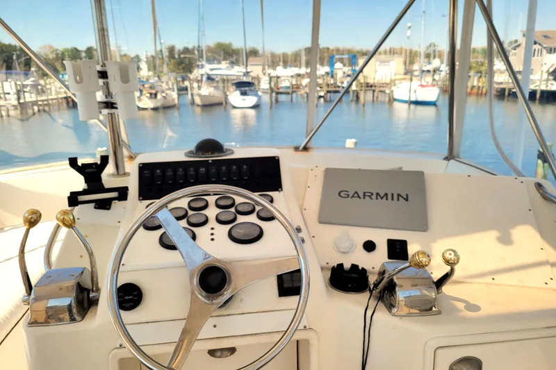 Slide: The Image of 1993 Ocean Yachts 38 Super Sport deck with two white chairs and patterned flooring. - 5