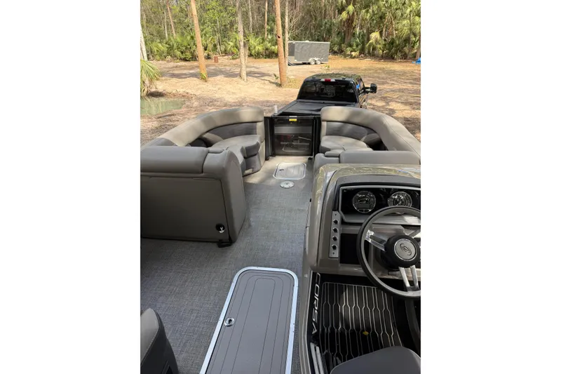 Slide: The Image of 2023 Barletta Corsa 23U pontoon boat interior with plush seating and modern dashboard. - 5