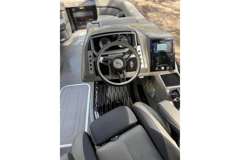 Slide: The Image of 2023 Barletta Corsa 23U boat dashboard with steering wheel and control panel. - 7