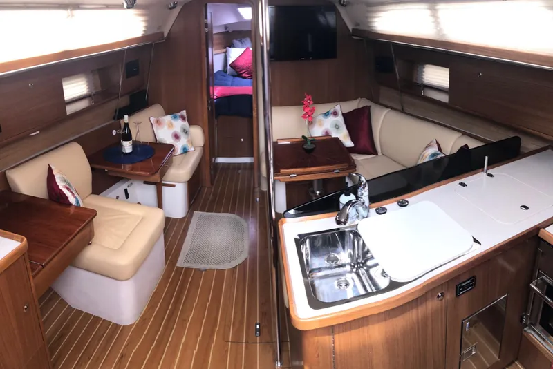 Slide: The Image of Luxurious interior of 2020 Catalina 355 yacht with modern kitchen and cozy seating area. - 1