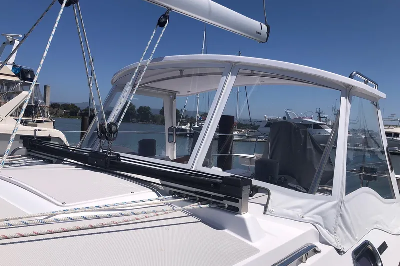 Slide: The Image of 2020 Catalina 355 sailboat with sleek design, docked in a marina under clear blue skies. - 16
