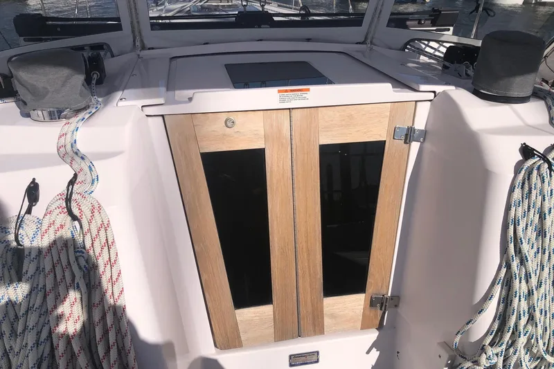 Slide: The Image of Cockpit of a 2020 Catalina 355 sailboat with wooden hatch doors and coiled ropes. - 22