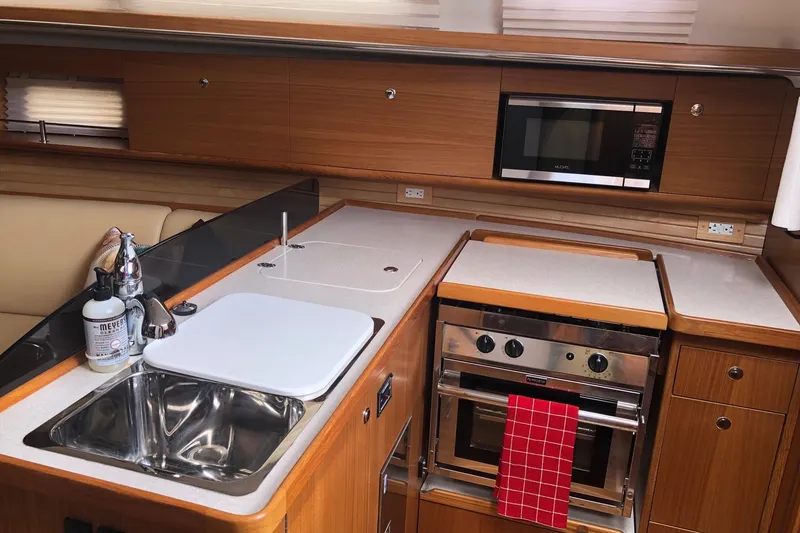 Slide: The Image of Modern kitchen interior of 2020 Catalina 355 yacht with stove, sink, and microwave. - 4