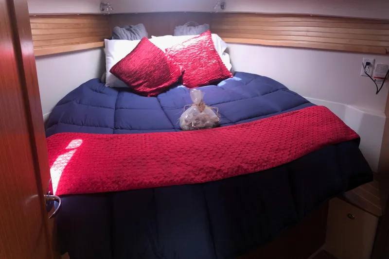 Slide: The Image of Cozy cabin bedroom in 2020 Catalina 355 yacht with red and blue bedding. - 5