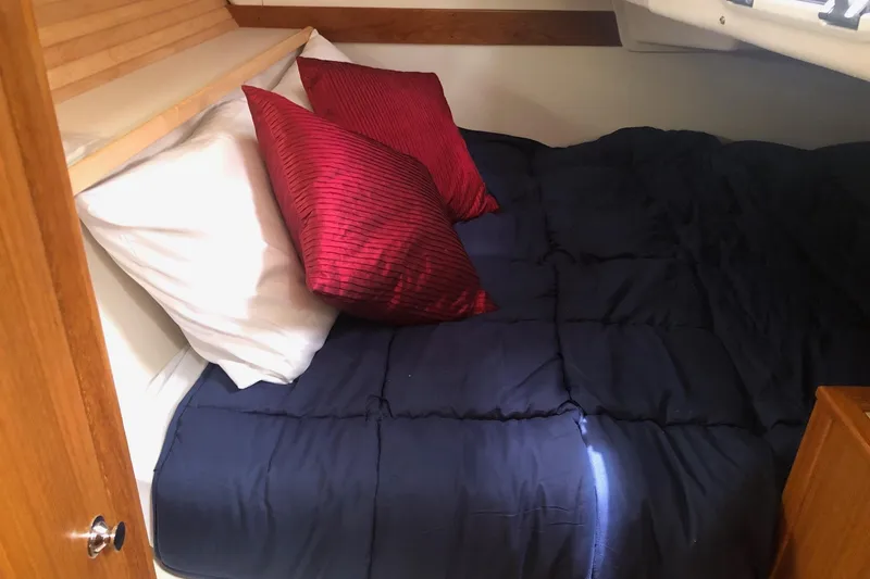Slide: The Image of Cozy cabin bed in 2020 Catalina 355 yacht with red and white pillows. - 6