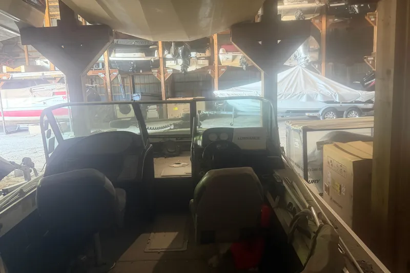 Slide: The Image of 1994 Smoker Craft 182 Pro Mag boat interior in storage, featuring seats and dashboard. - 4