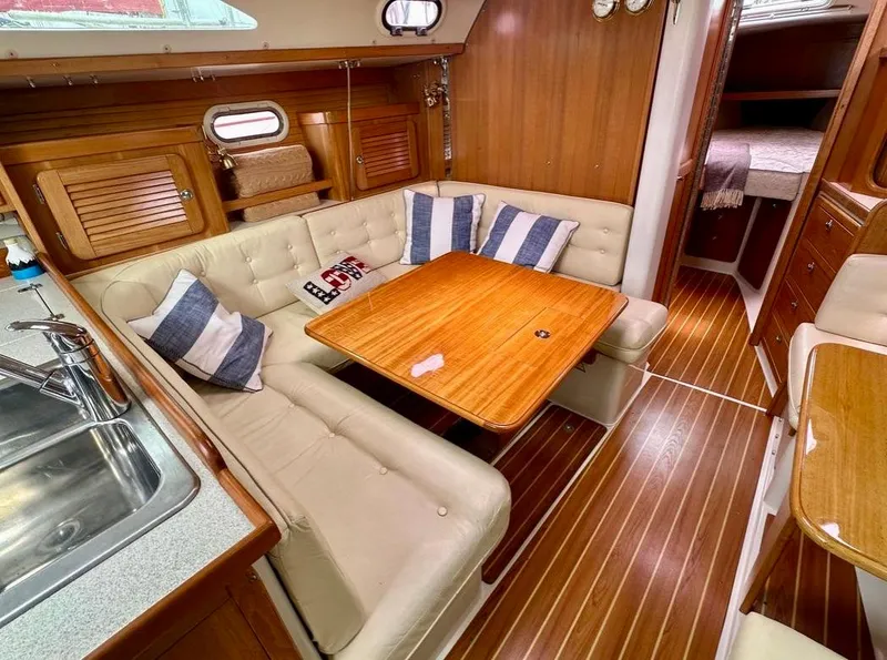 Slide: The Image of Interior of 2007 Catalina 36 MkII sailboat with cozy seating and wooden table. - 10