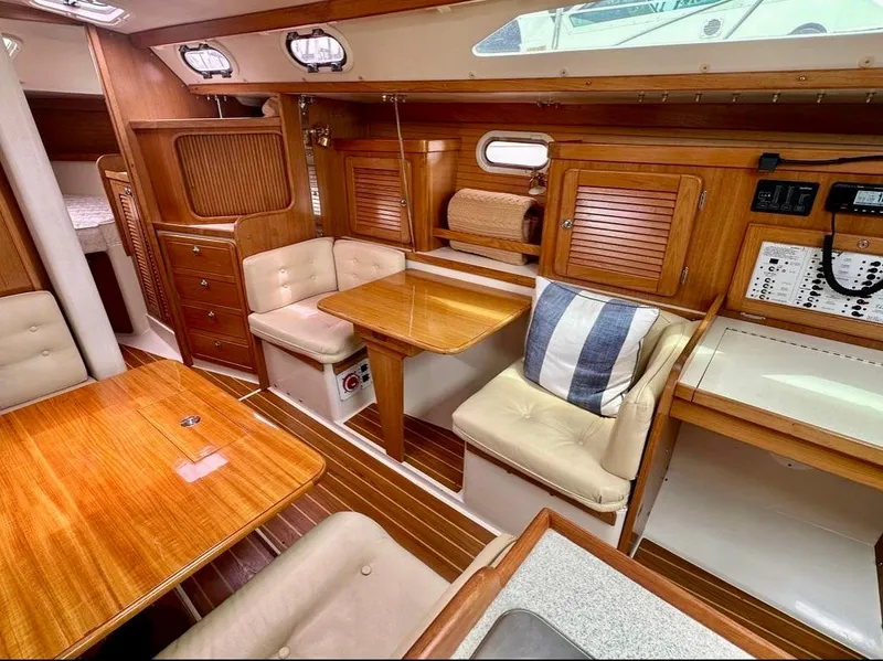Slide: The Image of Interior of a 2007 Catalina 36 MkII sailboat with wooden furnishings and cozy seating. - 11