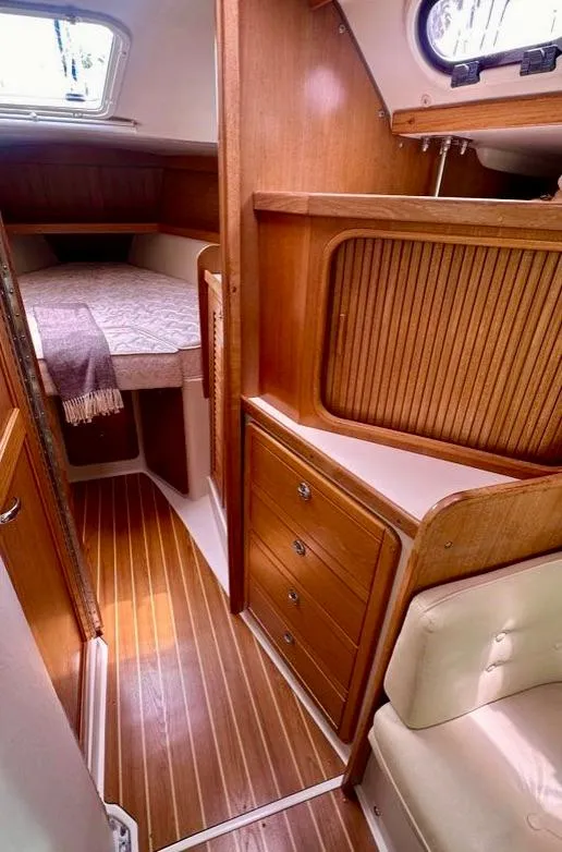 Slide: The Image of 2007 Catalina 36 MkII cabin interior with wood finish and cozy sleeping area. - 14