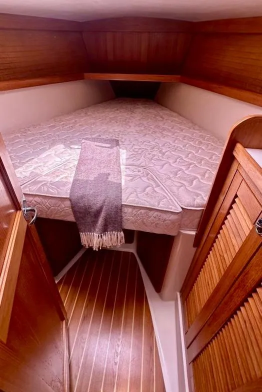Slide: The Image of 2007 Catalina 36 MkII cabin interior with cozy bed and wooden accents. - 16