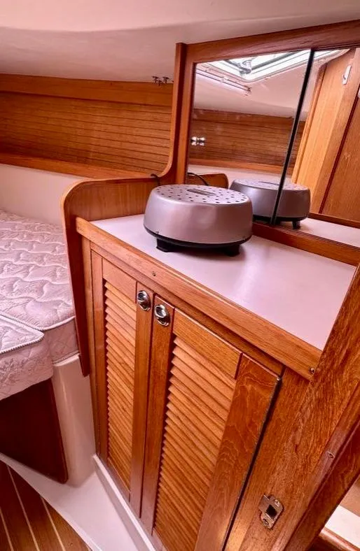 Slide: The Image of 2007 Catalina 36 MkII cabin interior with wooden cabinetry and mirrored storage. - 17