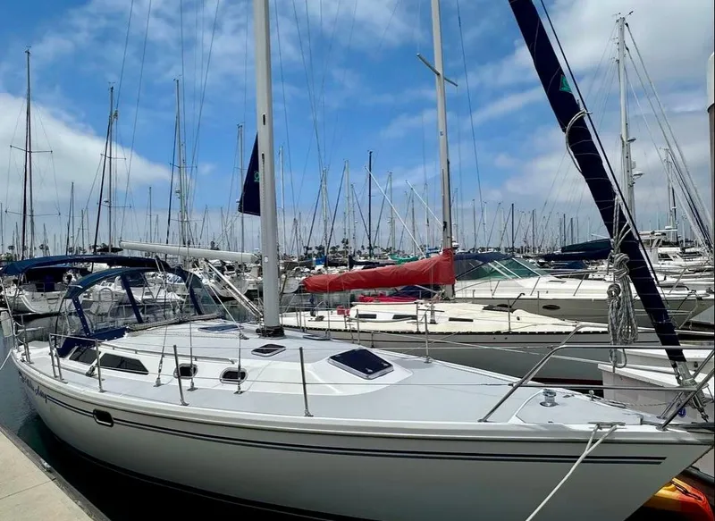 Slide: The Image of 2007 Catalina 36 MkII sailboat docked in a marina under a blue sky. - 2