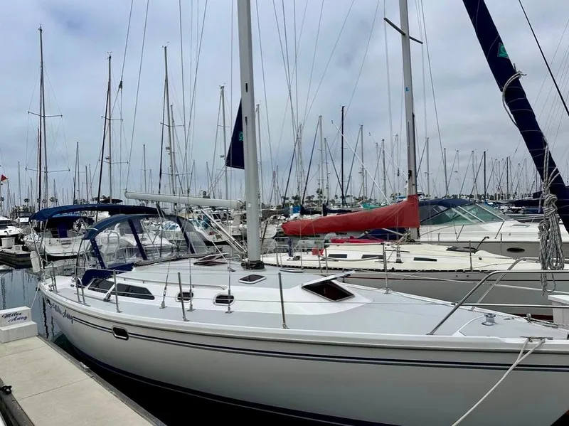 Slide: The Image of 2007 Catalina 36 MkII sailboat docked in a marina, surrounded by other boats. - 21