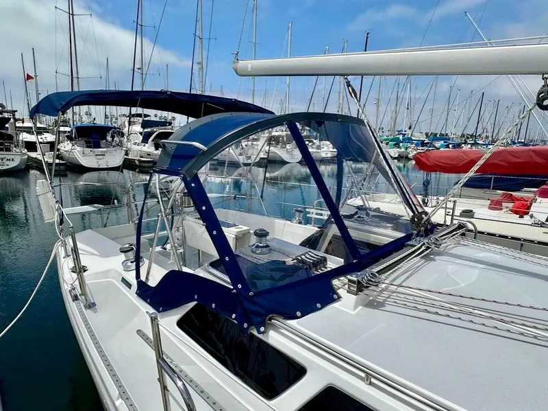 Slide: The Image of Catalina 36 MkII 2007 sailboat docked in a marina with blue canopy and clear enclosure. - 3