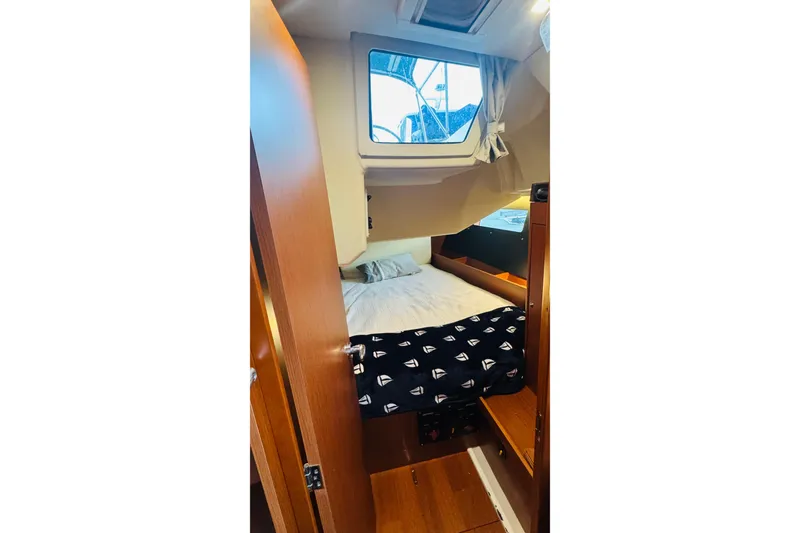 Slide: The Image of Cozy cabin interior of 2018 Beneteau Oceanis 41.1 sailboat with bed and window. - 13