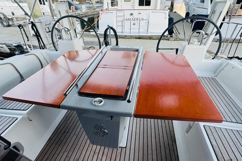 Slide: The Image of Cockpit of 2018 Beneteau Oceanis 41.1 with wooden table and dual steering wheels. - 15