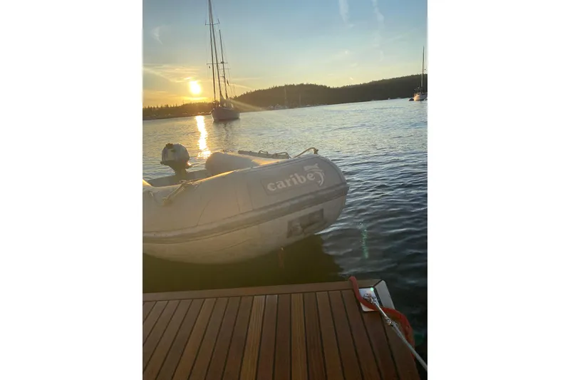 Slide: The Image of Sunset view from Beneteau Oceanis 41.1 yacht, featuring a Caribe inflatable boat. - 2