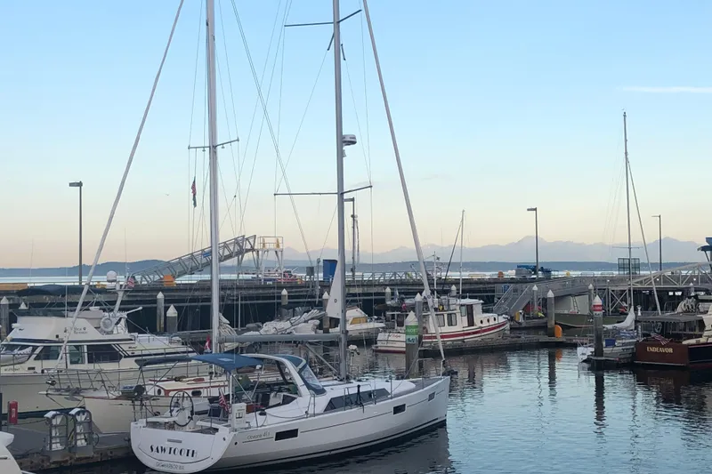 Slide: The Image of 2018 Beneteau Oceanis 41.1 sailboat docked in a serene marina setting. - 3