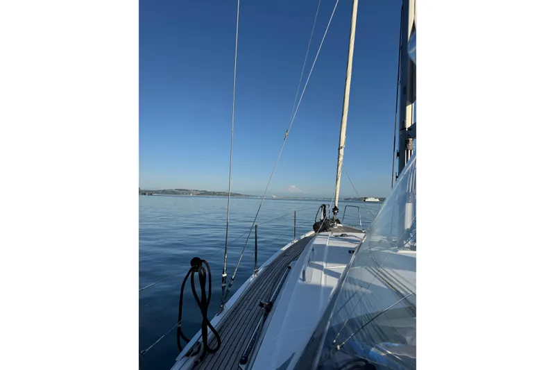 Slide: The Image of 2018 Beneteau Oceanis 41.1 sailboat on calm waters under clear blue sky. - 6
