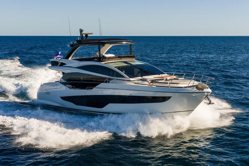 The Image of Luxurious 2024 Pearl 72 yacht cruising on open sea under clear blue sky. - 0