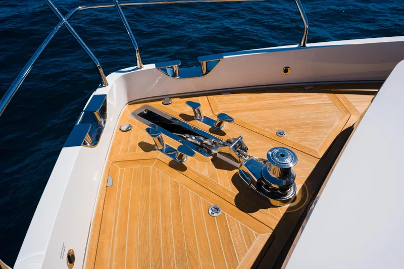 Slide: The Image of Bow of 2024 Pearl 72 yacht with teak decking and polished metal fittings. - 102