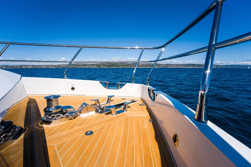 Slide: The Image of Bow of 2024 Pearl 72 yacht with teak deck and ocean view. - 103
