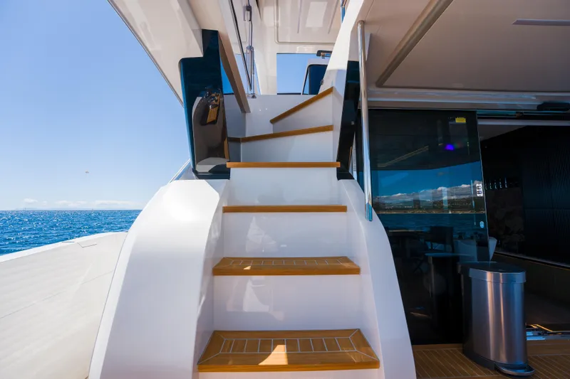 Slide: The Image of Staircase on 2024 Pearl 72 yacht with ocean view and modern interior. - 109